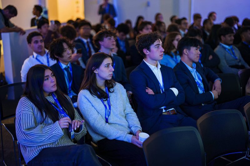 Students watching a presentation from the audience at the UK Investment Competition Grand Final