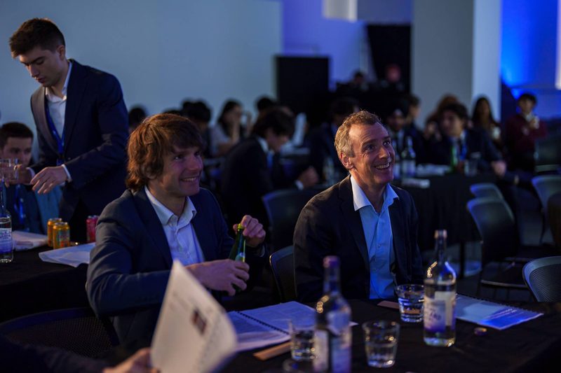 Two judges watching a pitch from the front table