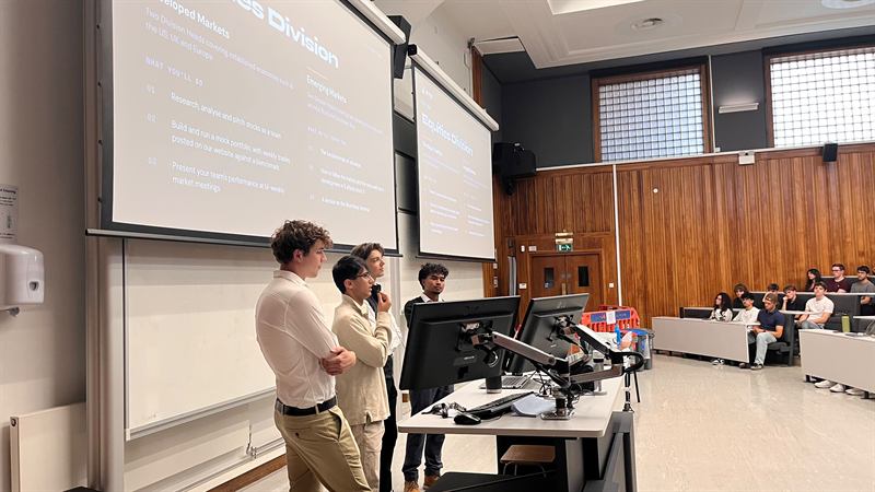 Committee members presenting the divisions at the front of the lecture theatre