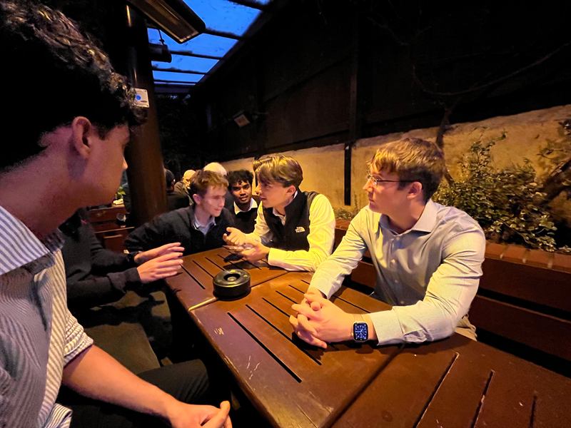 Members in conversation around a table after the Welcome Event